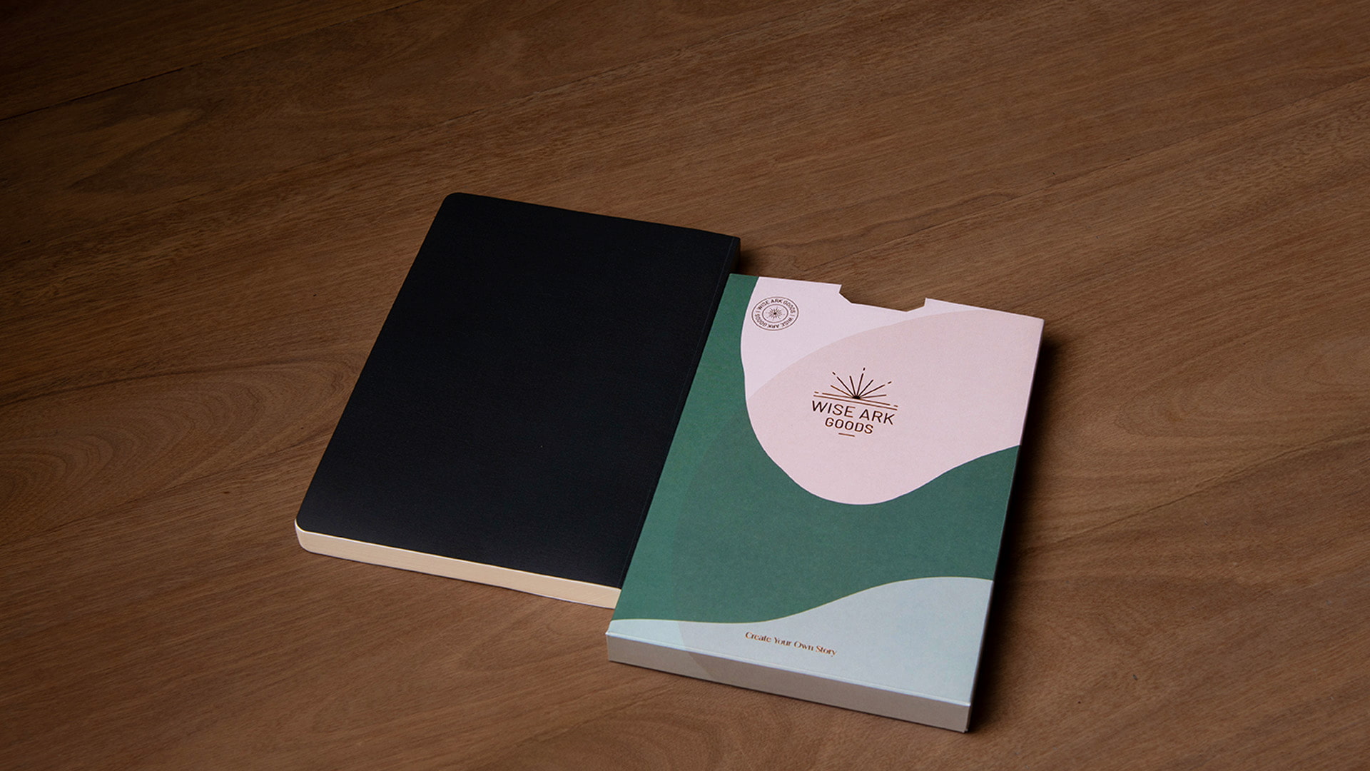 main image of notebook and packaging sleeve side by side on wooden table top